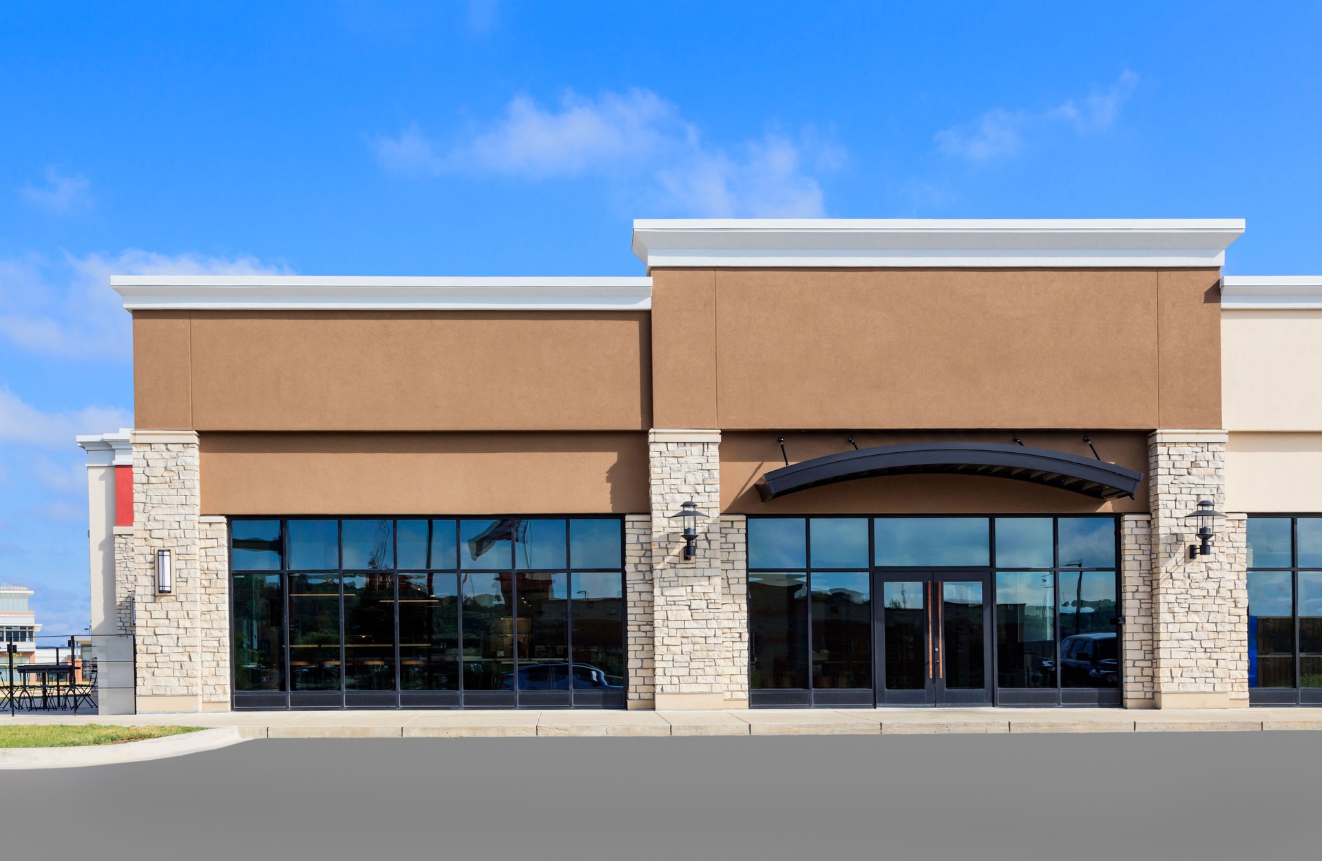 Pre-engineered commercial metal retail building with stone and stucco facade in Texas