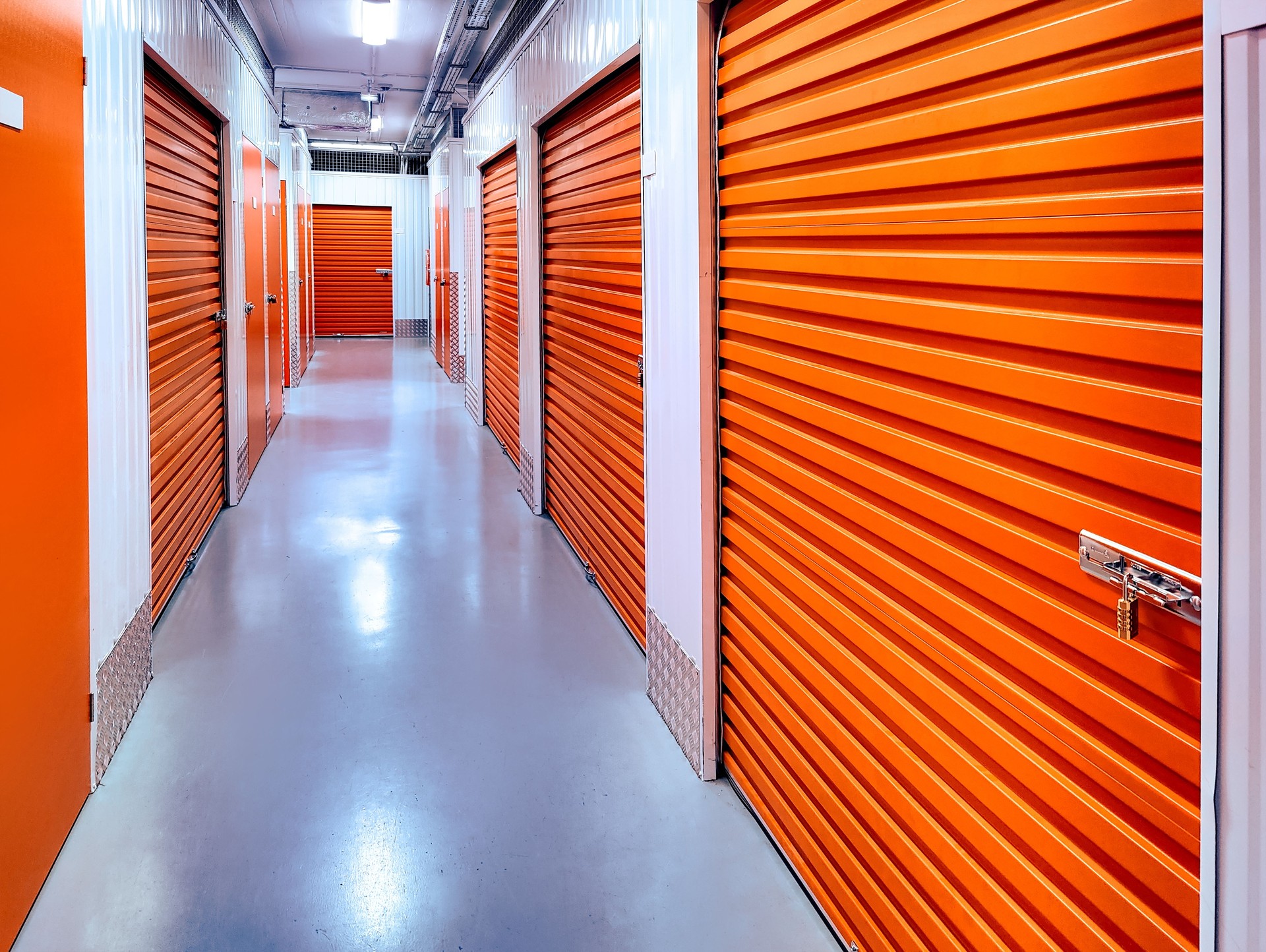 Indoor climate-controlled storage building with orange roll-up doors