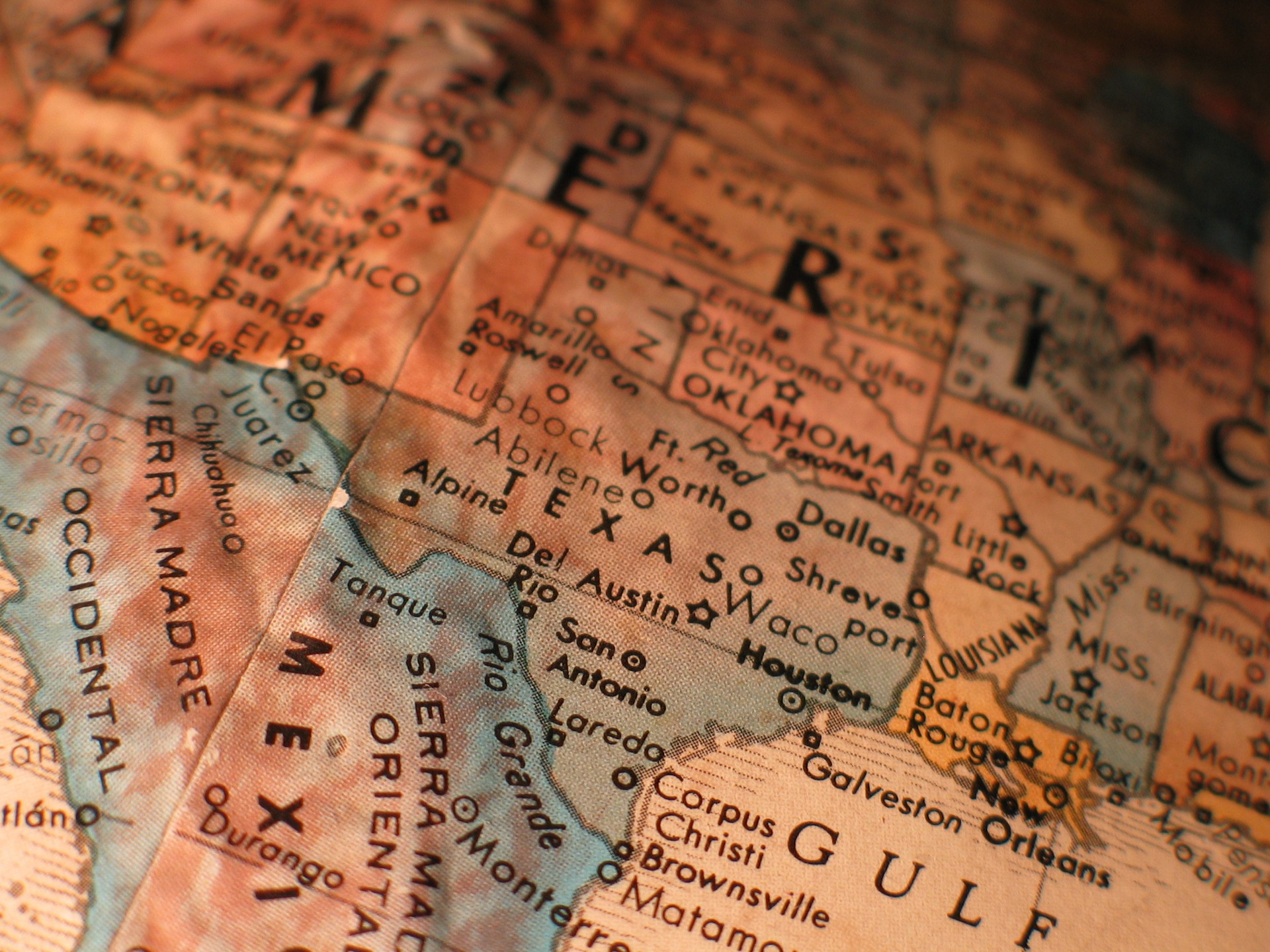 Vintage globe close-up showing Texas cities like San Antonio, Austin, and Dallas, representing Texas Metal Buildings.